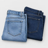 Two pairs of old blue jeans before being upcycled into a backpack