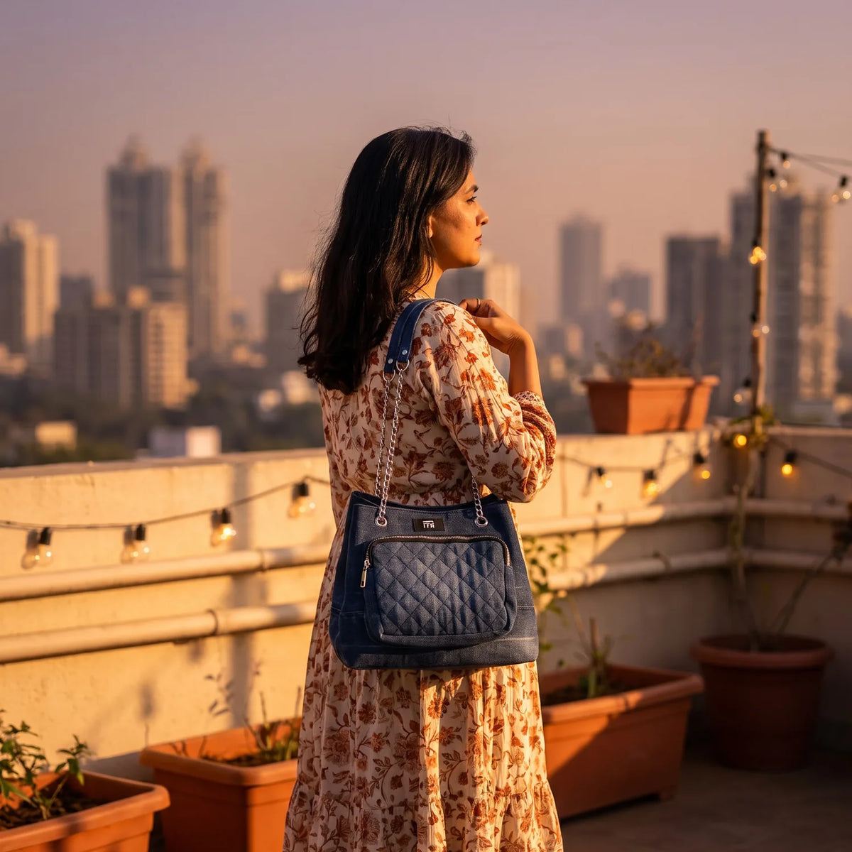 Quilted Drawstring bag carried by a model, made from upcycled jeans