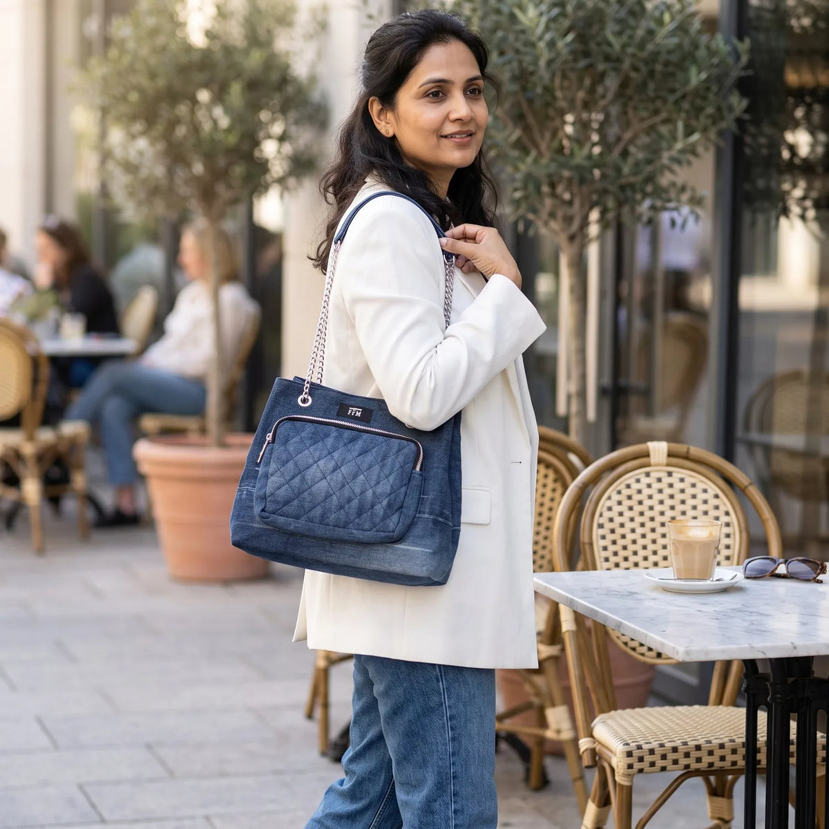 Quilted Drawstring bag carried by a model, made from upcycled jeans