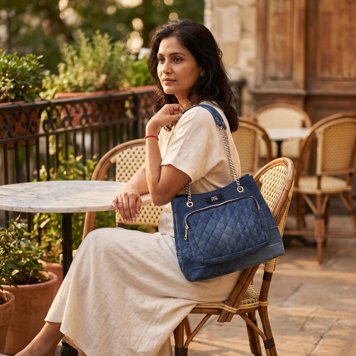Quilted Drawstring bag carried by a model, made from upcycled jeans