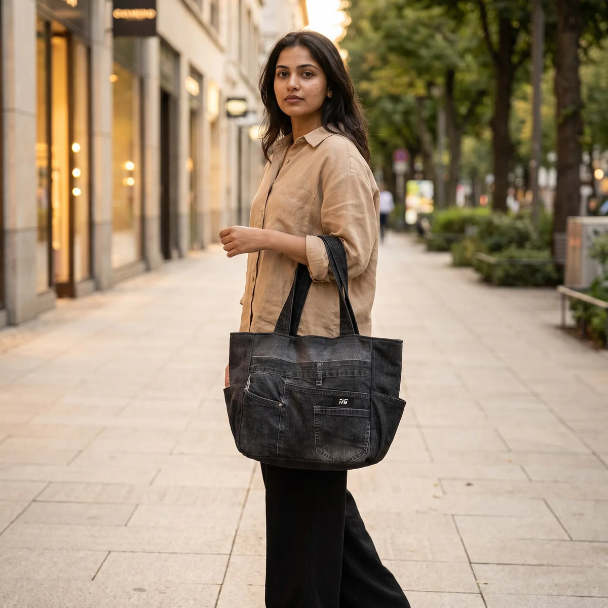 Seamline Meridian tote carried by a model, made from upcycled jeans