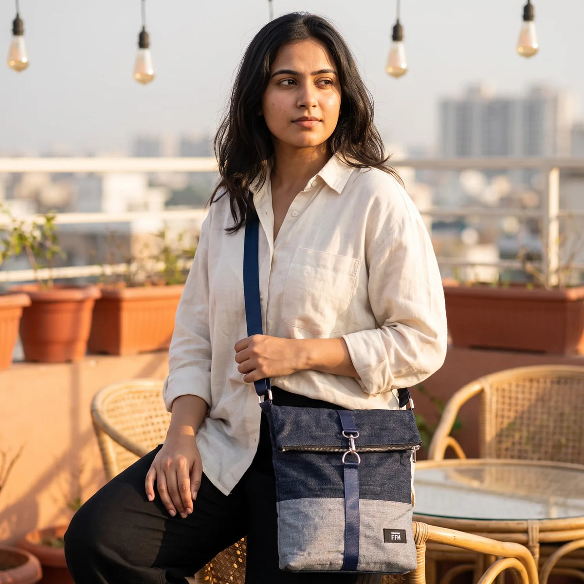 Terra Fold crossbody bag carried by a model, made from upcycled jeans