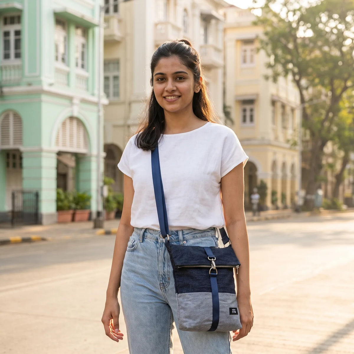 Terra Fold crossbody bag carried by a model, made from upcycled jeans